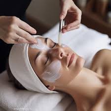 A person receiving a luxurious facial treatment at a beauty spa, with natural products being applied to enhance skin radiance