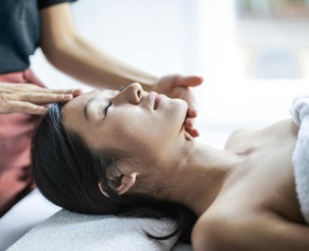 A woman receiving a relaxing body treatment at a spa, with soothing techniques designed to relieve stress and promote rejuvenation