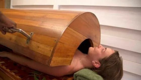 A person undergoing Swedana, an Ayurvedic steam treatment, to detoxify the body and relieve muscle tension.