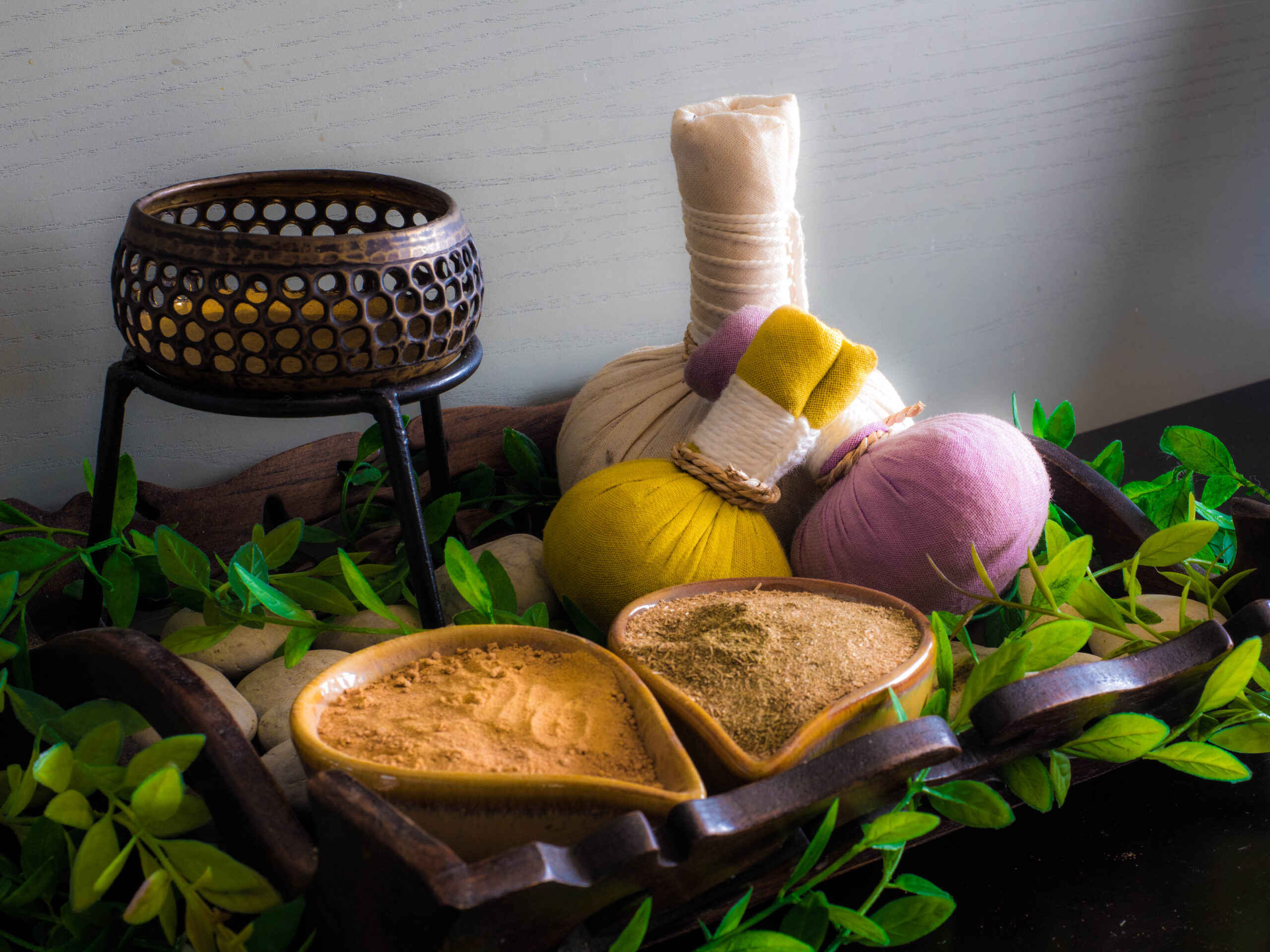 A collection of Ayurvedic medicines, herbs, and powders arranged for natural healing treatments.